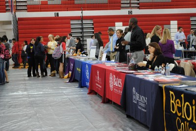 Colleges await interested students at their booths on College Night. Photo by Vicky Robles.