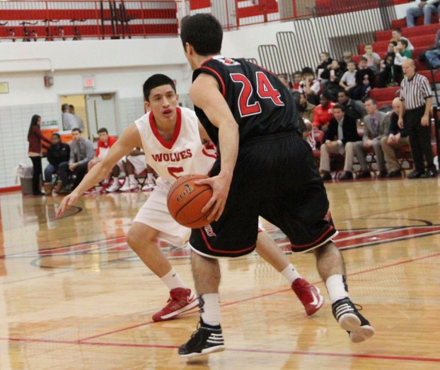 Senior Alfredo Gonzalez defends a Maine South ball handler during Friday's loss to the Hawks. Maine South won 50-29. PHOTO by Vinny Kabat