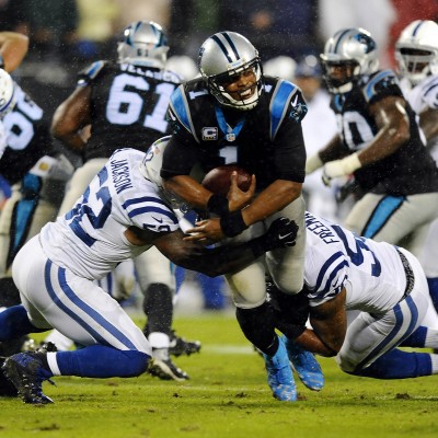 Carolina Panthers' Cam Newton (1) breaks past Indianapolis Colts' D'Qwell Jackson (52) and Jerrell Freeman (50) for a first down during the first quarter on Monday, Nov. 2, 2015, at Bank of America Stadium in Charlotte, N.C. (David T. Foster III/Charlotte Observer/TNS)