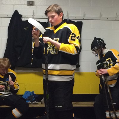 Sophomore Vadym Scherba waxes his hockey stick before a game
