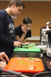 Valy Ghivrca cuts vegetables for an omelet during eighth period chef's course. PHOTO by Kasia Ciesielska 