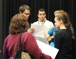 Director Andy Sinclair discusses last-minute changes with the crew at the final practice Thursday, Dec. 12. Photo by Katrina Nickell