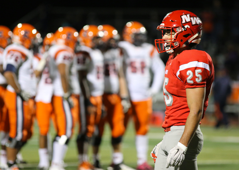 Senior Yaniv Shields walks off the football field after a devastating lost against the Evanston Wildkits (27-42) at his last Homecoming Football game on Friday, Oct. 2, 2015. Photo by Jenna George